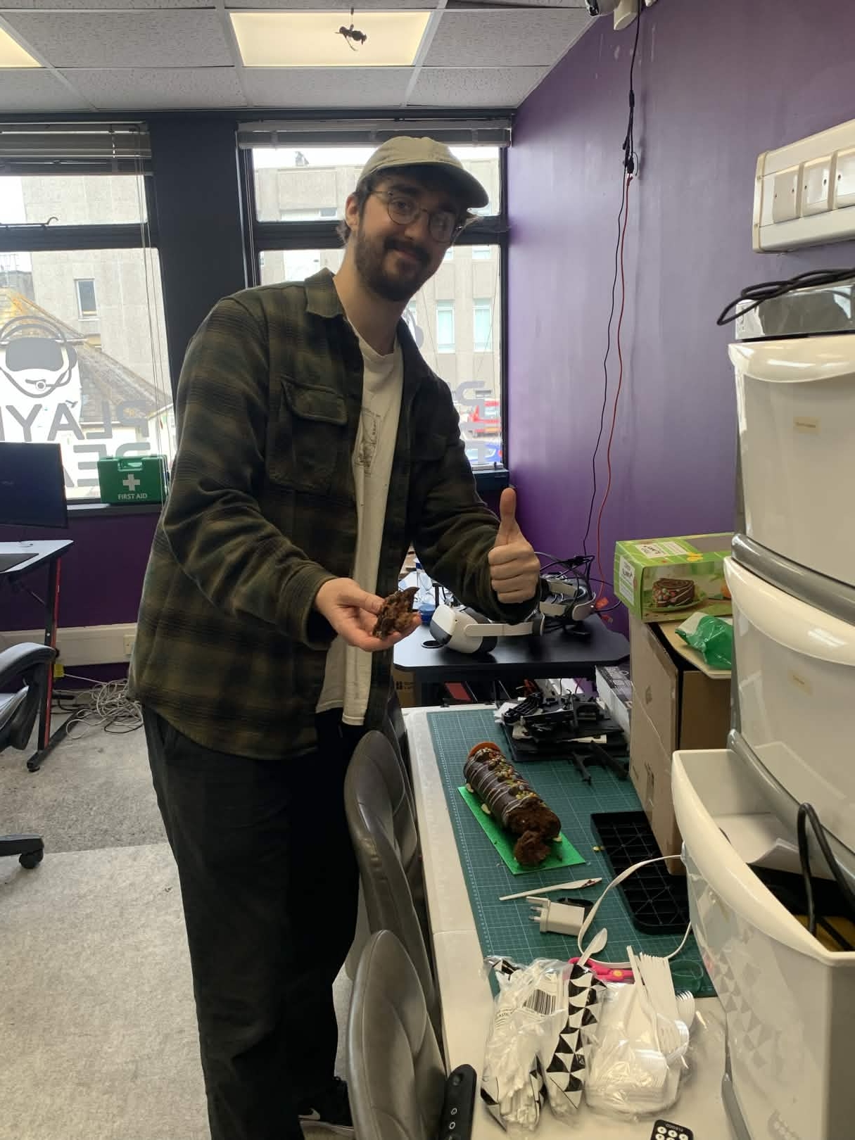 A student proudly displays their completed 3D printed project - a segmented articulated structure showing excellent patience and assembly skills. The detailed print demonstrates understanding of how individual components fit together to create a flexible, moving piece.