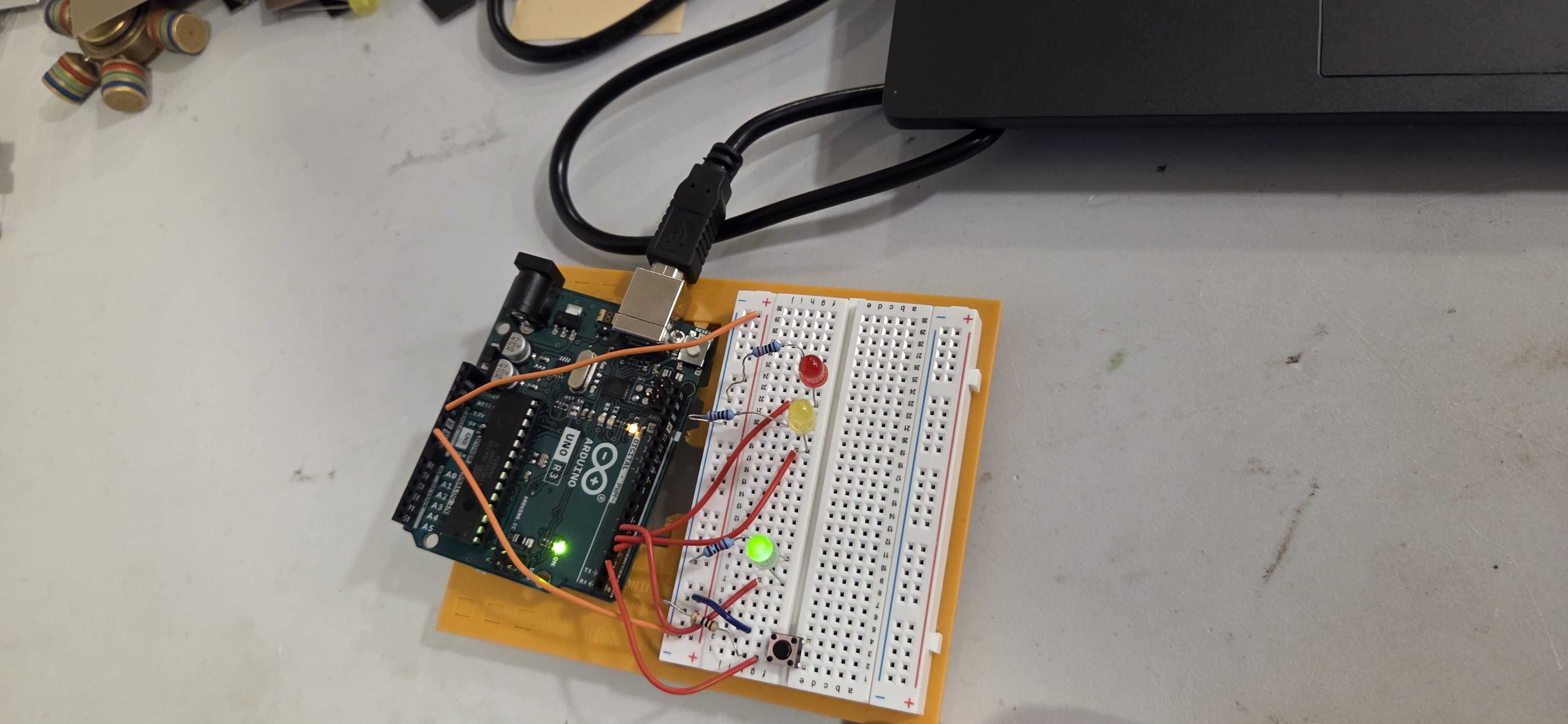 A student's electronics project featuring an Arduino board connected to a breadboard circuit with LEDs and components. This hands-on coding and robotics activity demonstrates practical programming skills as students learn to control physical hardware through code.