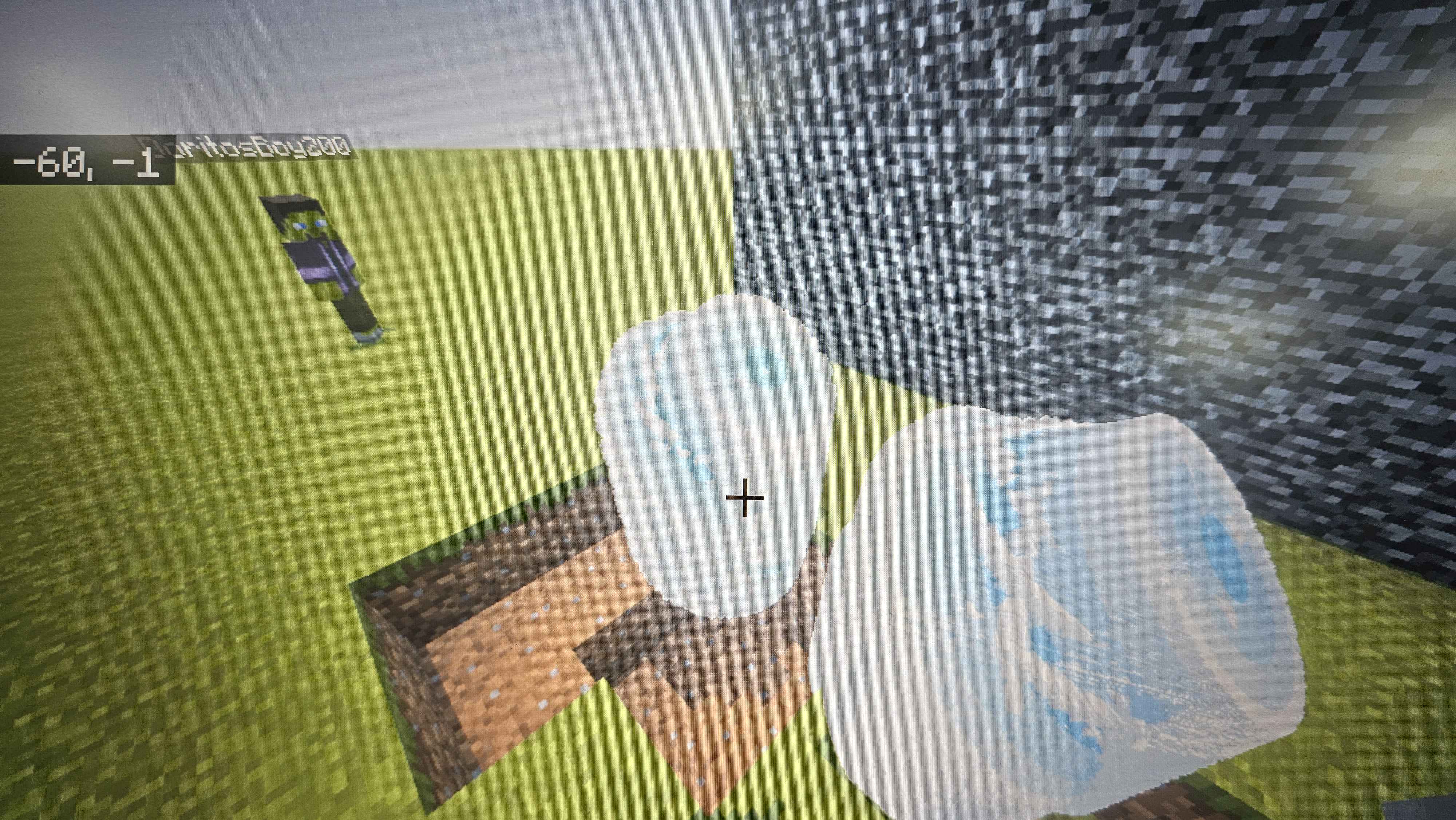 A student creates custom structures in Minecraft, building with ice blocks and experimenting with terrain modification. This session demonstrates creative building skills and understanding of block placement mechanics.