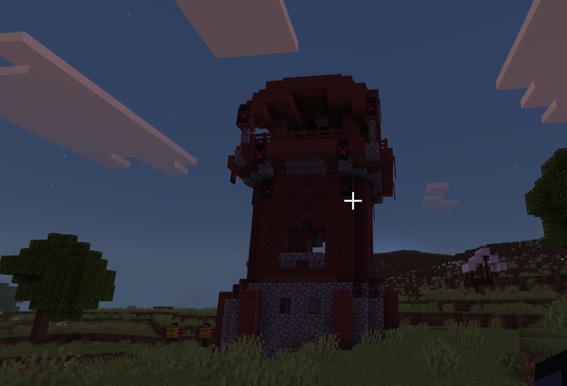 A detailed Minecraft build featuring a custom tower structure with intricate architectural details in dark red tones. The student has created a multi-tiered design with decorative elements and careful attention to shape and form.